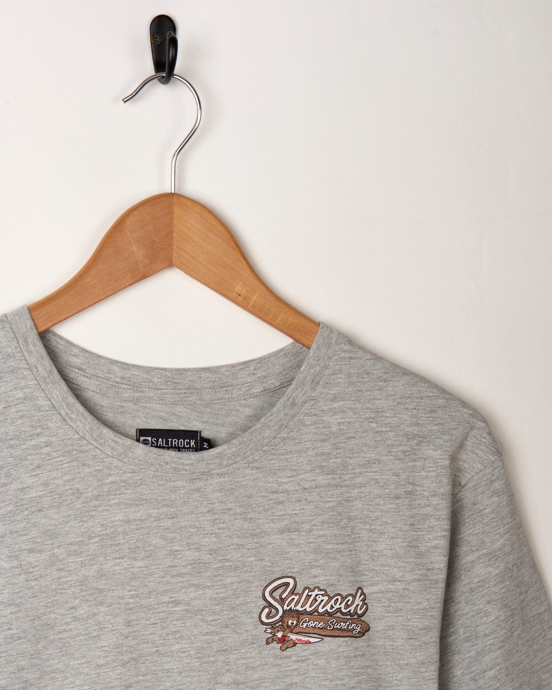 A grey Beach Signs Cornwall t-shirt featuring the iconic Saltrock branding in brown.