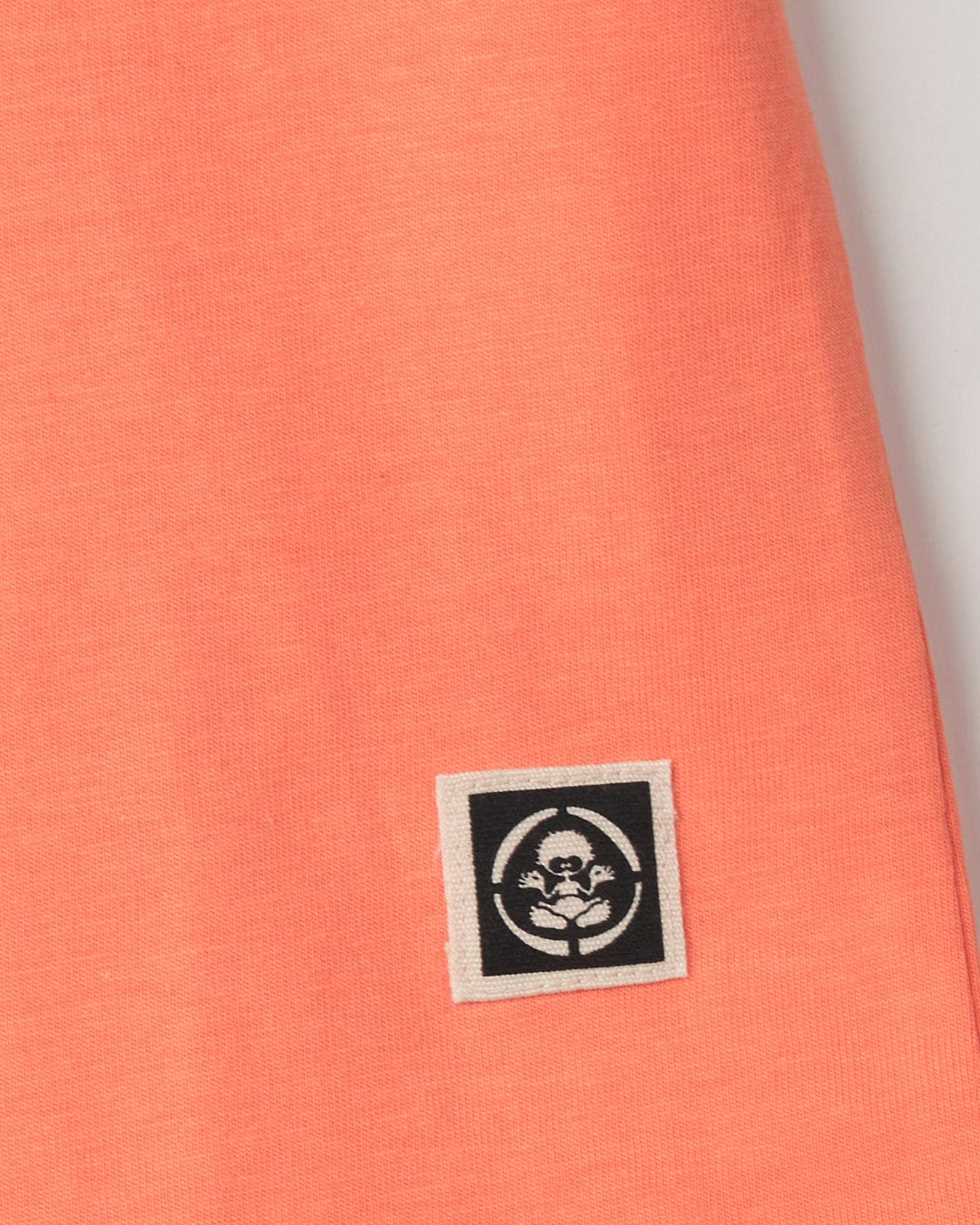 An orange Beach Signs Cornwall - Kids Short Sleeve T-Shirt with a black Saltrock branding logo on it.