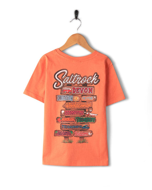 A machine washable Beach Signs Devon - Kids Short Sleeve T-Shirt - Orange with the words st. john's - st. john's by Saltrock.