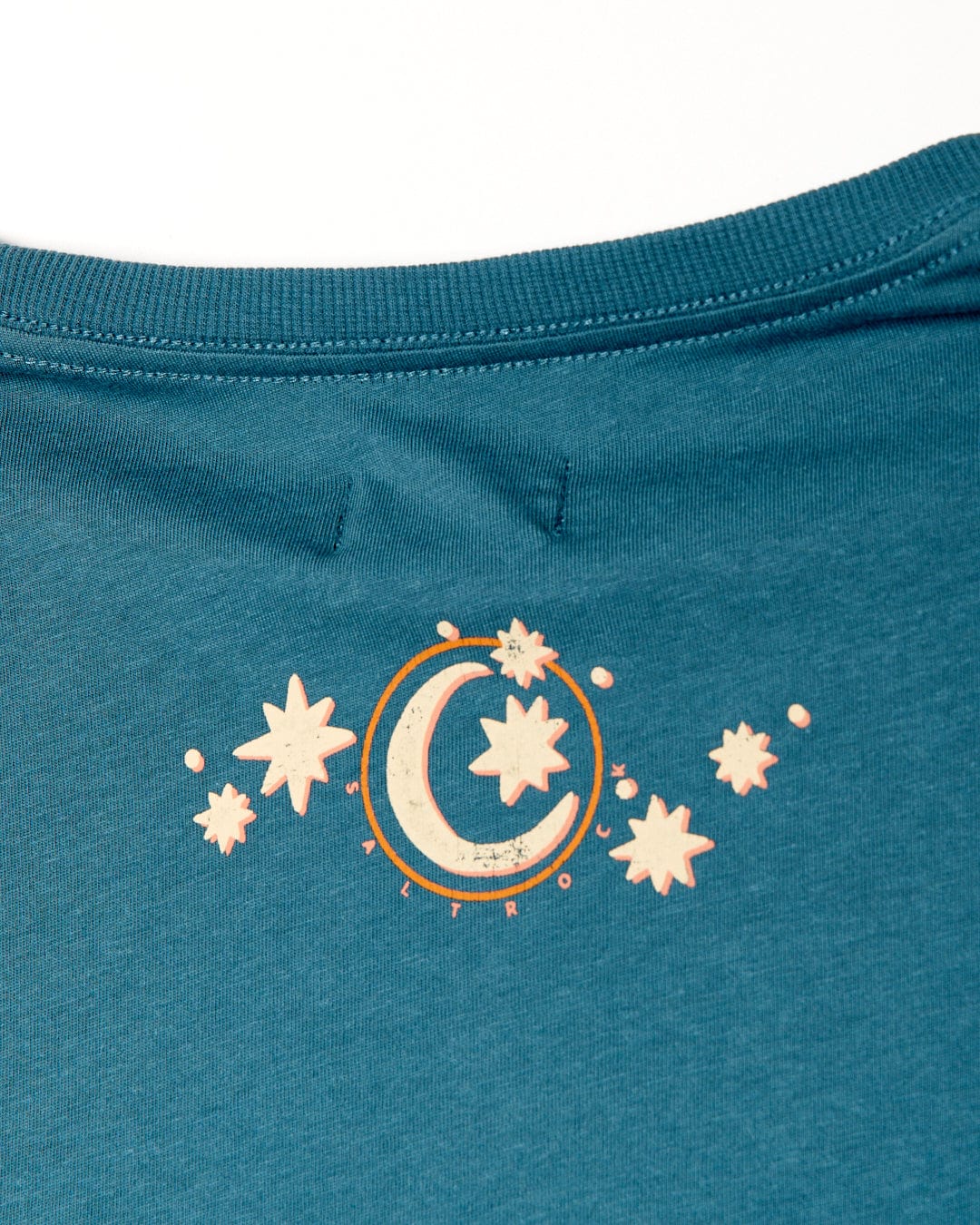 Close-up of a Saltrock Better Days - Recycled Womens Short Sleeve Relaxed T-Shirt in Teal with a white luna crescent moon and stars design printed near the collar.