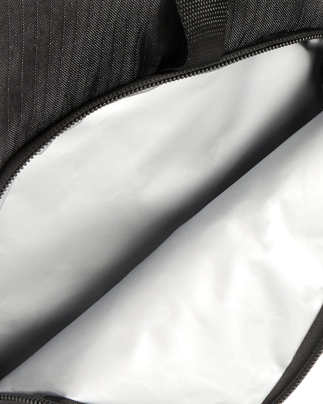 The inside of a Saltrock Boardwalk - Backpack - Black with a zipper.