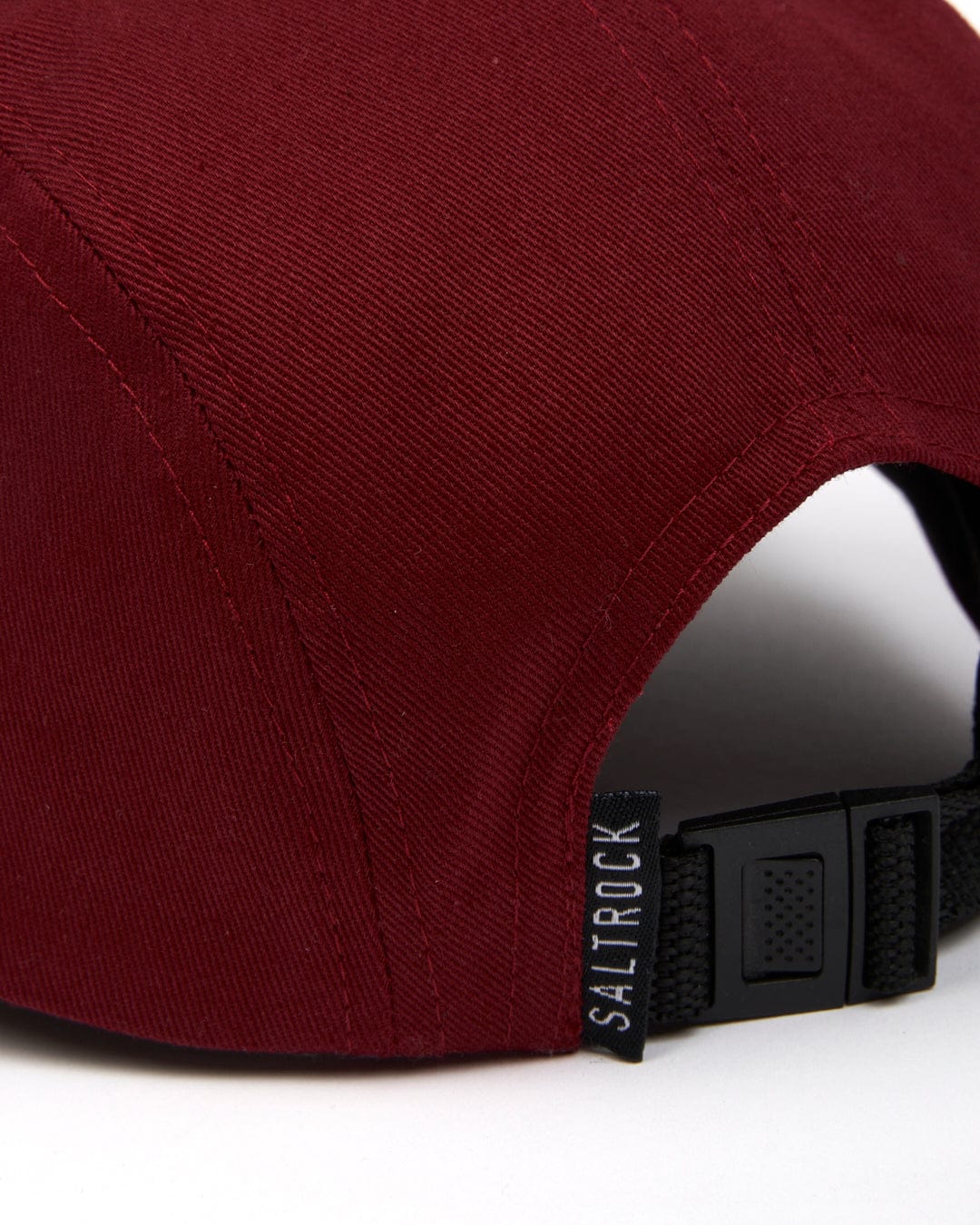 Close-up of a Saltrock Boardwalk - 5 Panel Cap - Red with an adjustable black strap and panels.