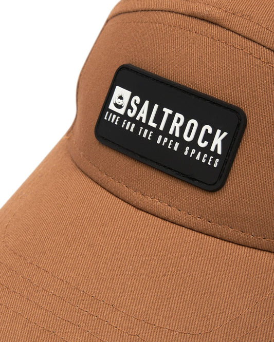 Close-up of a Boardwalk - 5 Panel Cap - Brown featuring a Saltrock logo patch and an adjustable strap.