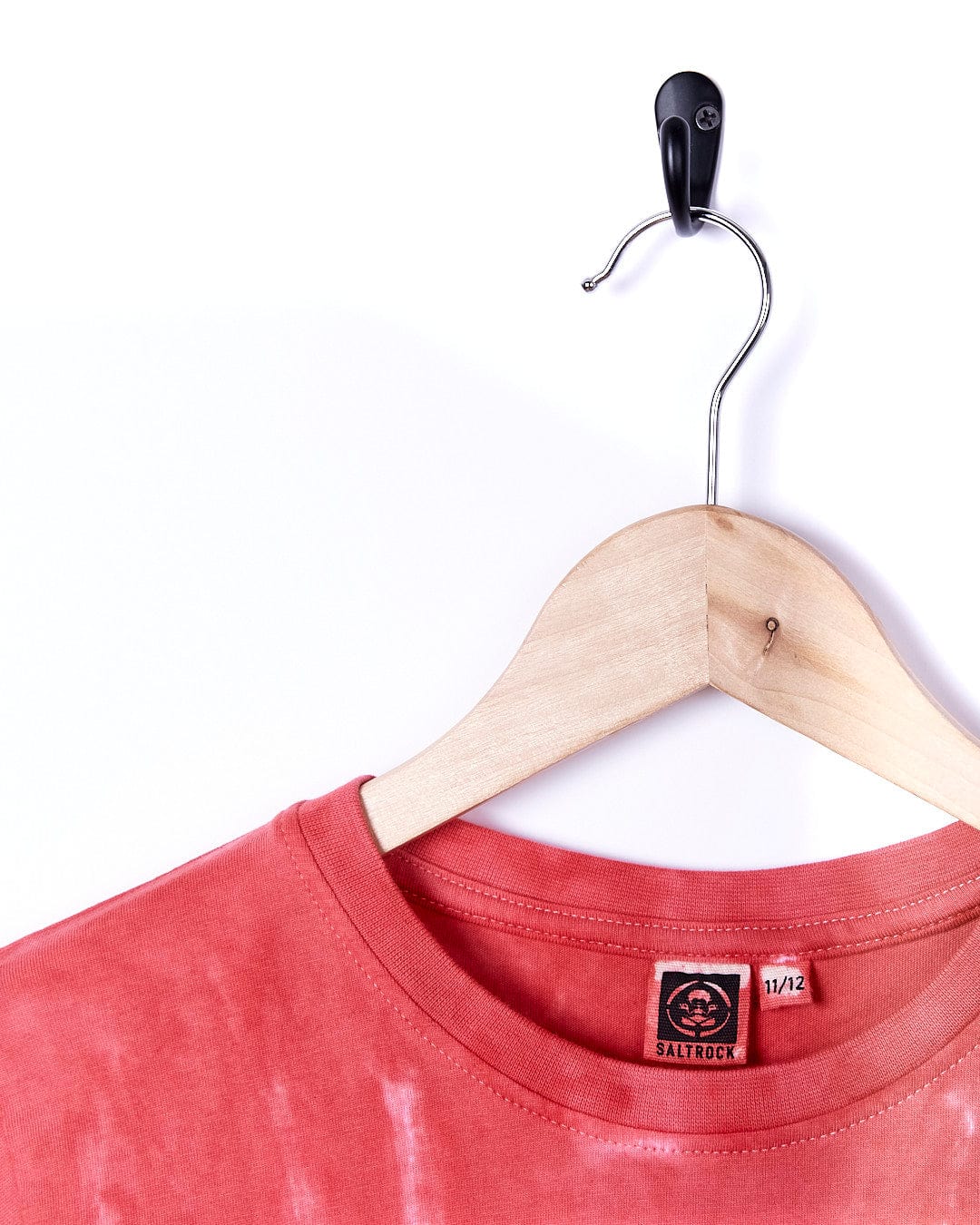 A Born To Ride - Kids Short Sleeve T-Shirt - Red hangs on a wooden hanger by Saltrock.