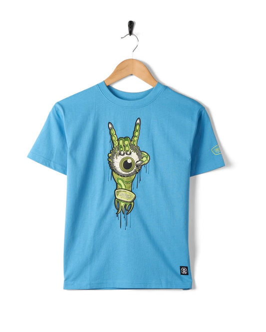 Sentence with replaced product: Bowling for Surf - Kids Short Sleeve Glow in the Dark T-Shirt with a Saltrock skateboard logo graphic print hanging on a hook against a white background.