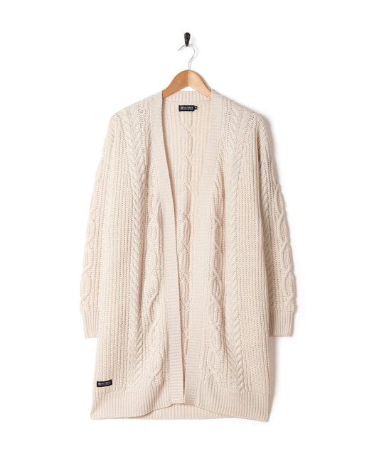 Cream cable-knit longline cardigan on a hanger against a white background.