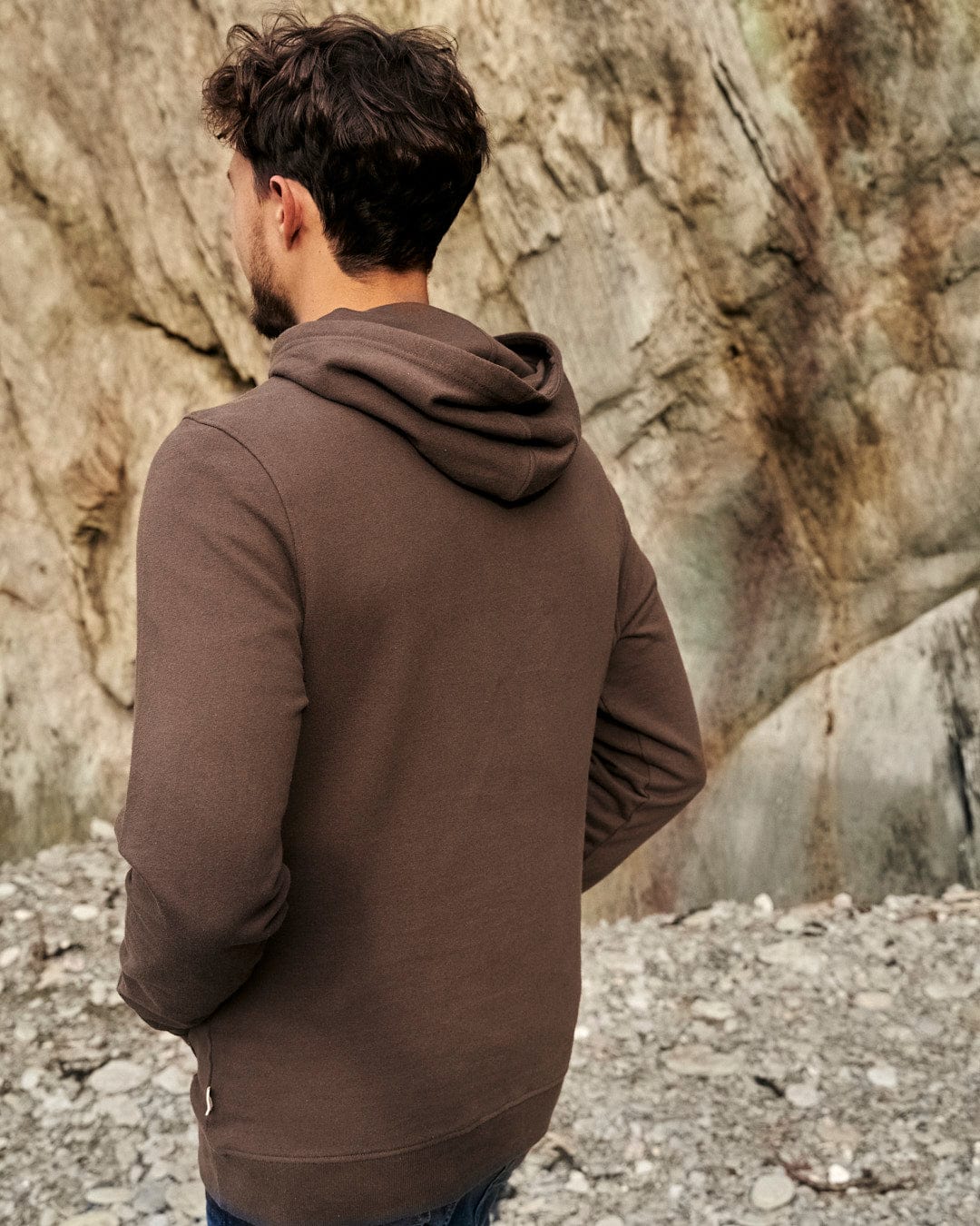 The back of a man wearing a Saltrock Camping Cabin - Mens Pop Hoodie - Brown.