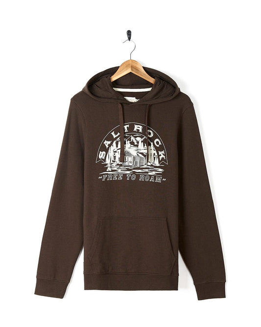A Camping Cabin - Mens Pop Hoodie - Brown with Saltrock graphics on it.