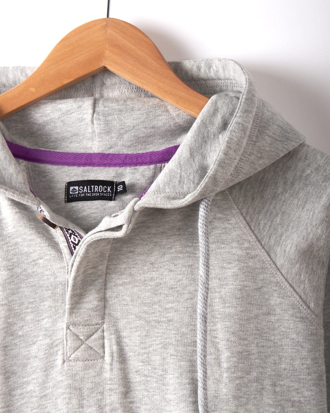 The Saltrock Cliffden Women's Pop Hoodie in grey, made from cotton, features a drawstring hood, visible brand label inside the neckline, and is machine washable—combining style and comfort.