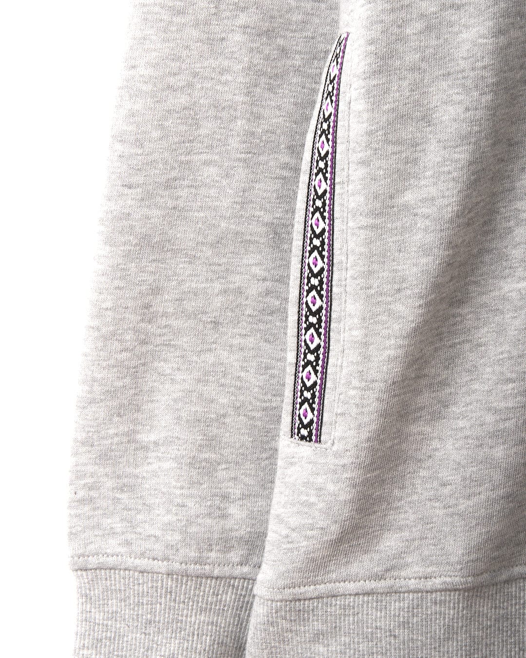 Close-up of the Cliffden - Womens Pop Hoodie in Grey by Saltrock shows a gray cotton sleeve with a geometric black, white, and pink vertical trim. This machine washable hoodie combines comfort and distinctive style.