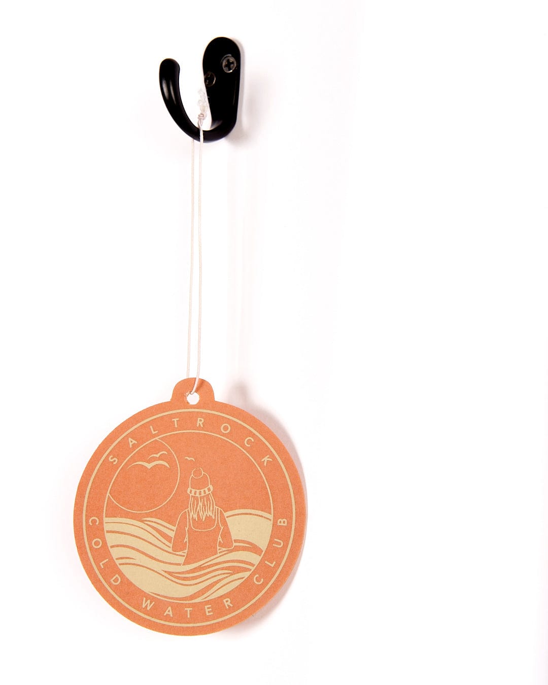 A Cold Water Club coconut-scented air freshener hanging on a hook by Saltrock.