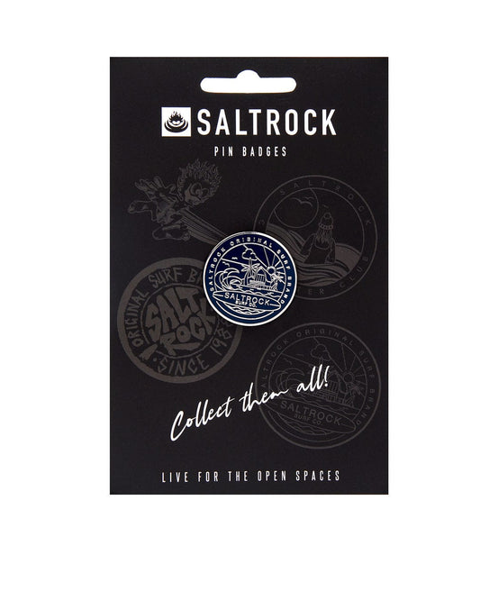 A packaging card displaying a collection of Saltrock Retreat pin badges with a safety clasp and the slogan "collect them all!" alongside the phrase "live for the open spaces".
