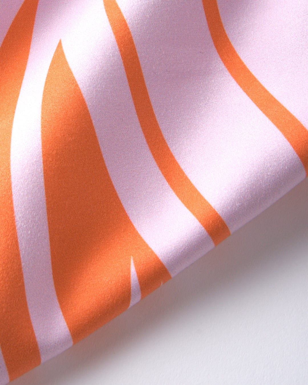 A close up of a Cold Water Club - Microfibre Towel - Orange and white striped absorbent fabric by Saltrock.