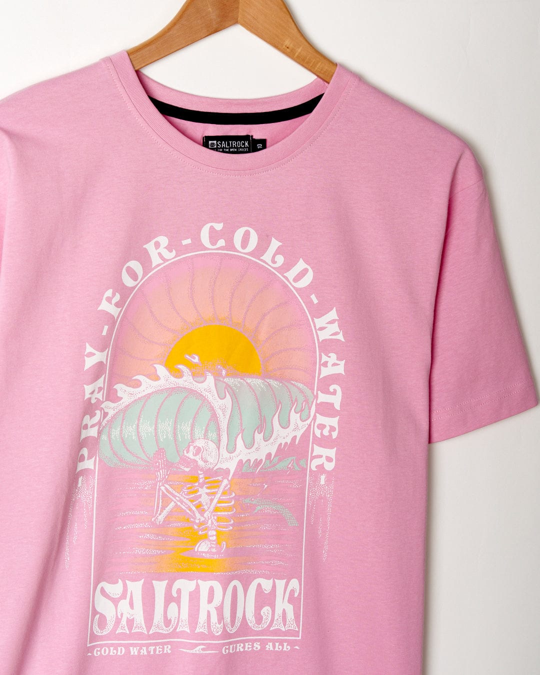 A pink cotton t-shirt with the words "Saltrock" on it.