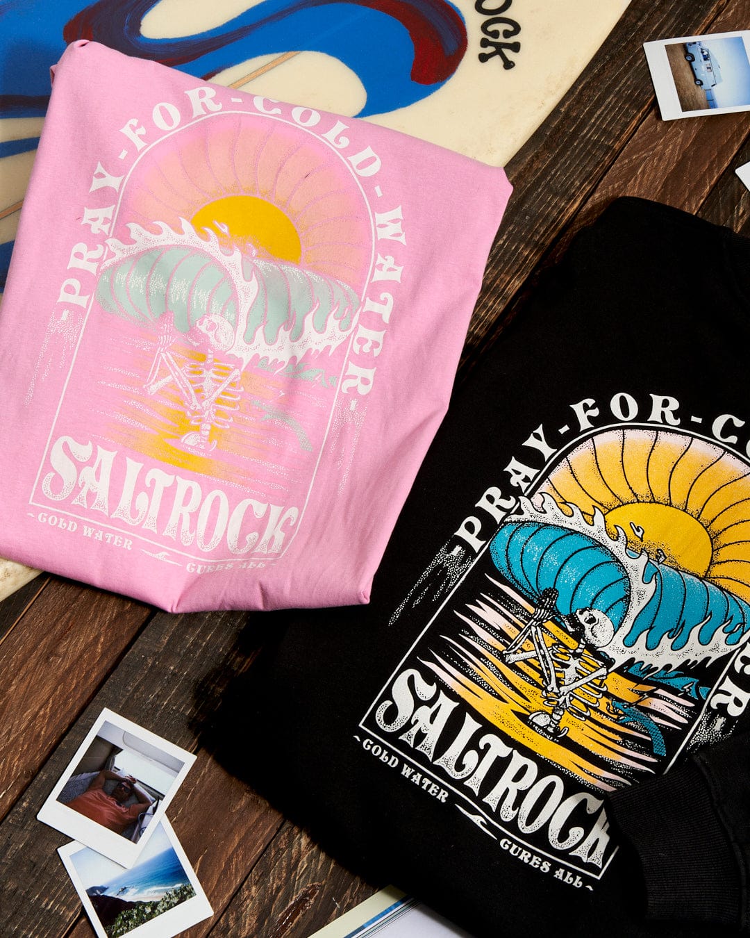 Two Cold Water - Womens Short Sleeve T-Shirts in Pink and a surfboard on a table.