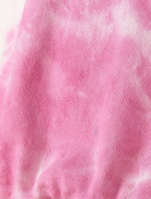 A Coralia - Kids Tie Dye Crew Sweat - Pink fabric with white spots. (Brand: Saltrock)