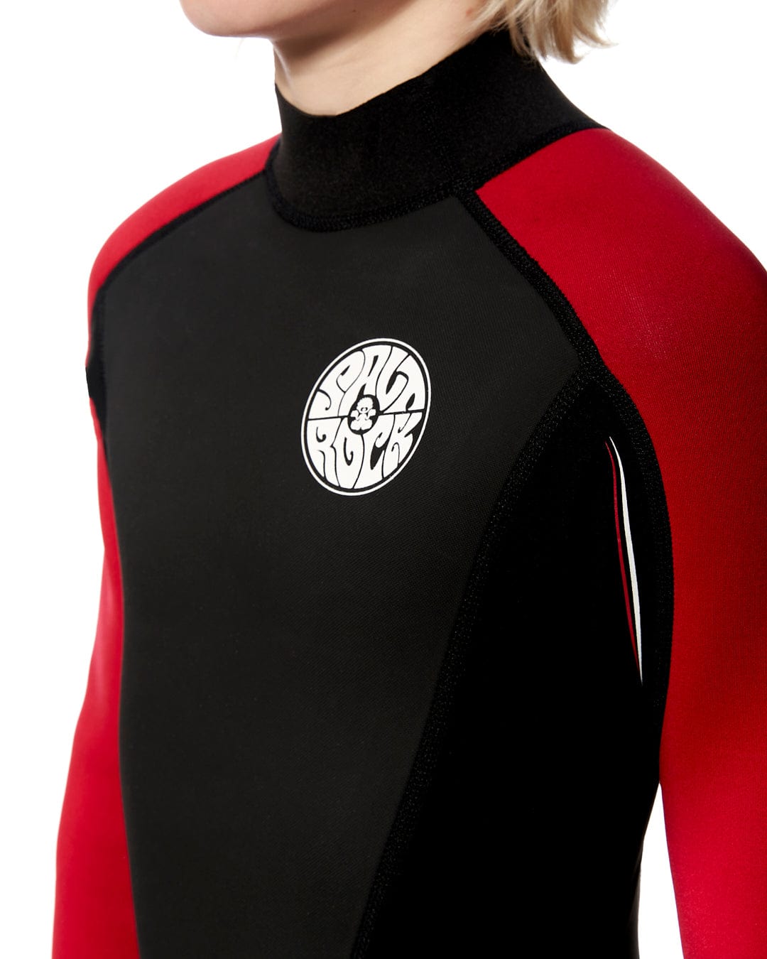A young boy wearing a Saltrock Core - Kids 3/2 Full Wetsuit - Red.