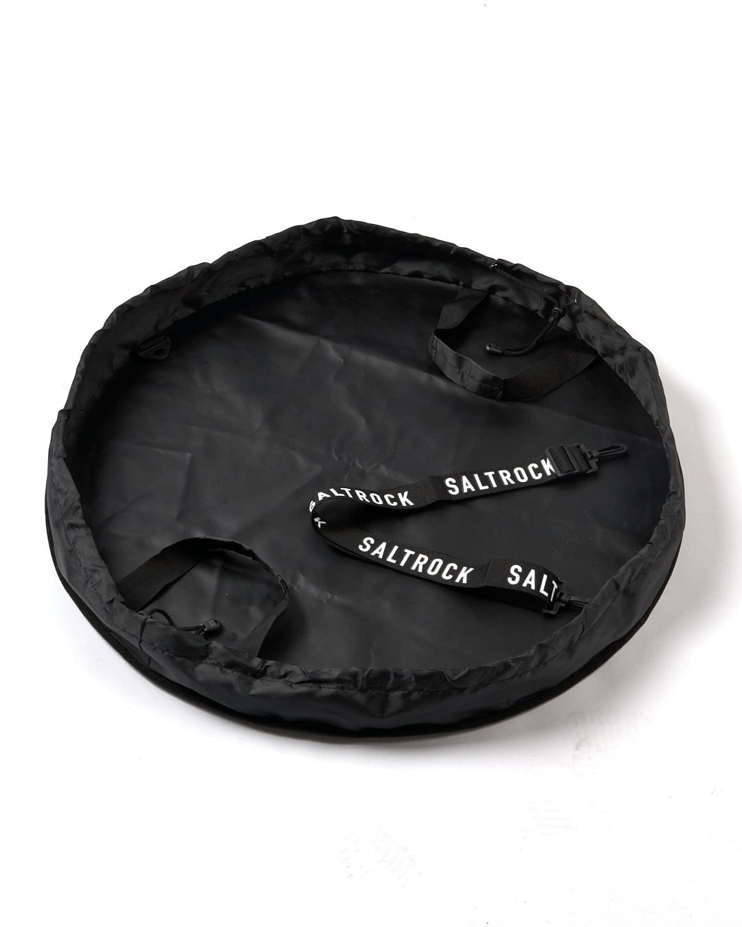 A round black lightweight Core Surf Changing Mat - Black/White with a strap attached to it by Saltrock.