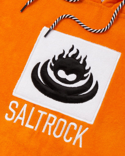 Close-up of a flamehead graphic Saltrock logo patch on an Corp Changing Towel - Orange fabric.