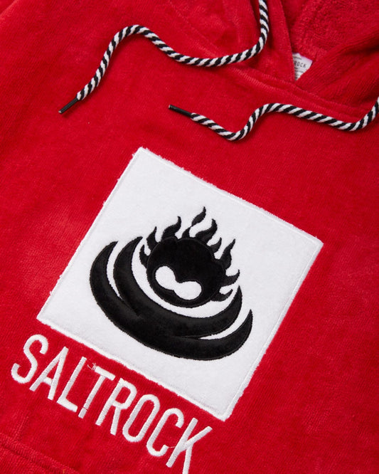 Close-up of an embroidered Saltrock logo on a red cotton towelling Corp Changing Towel with a drawstring.