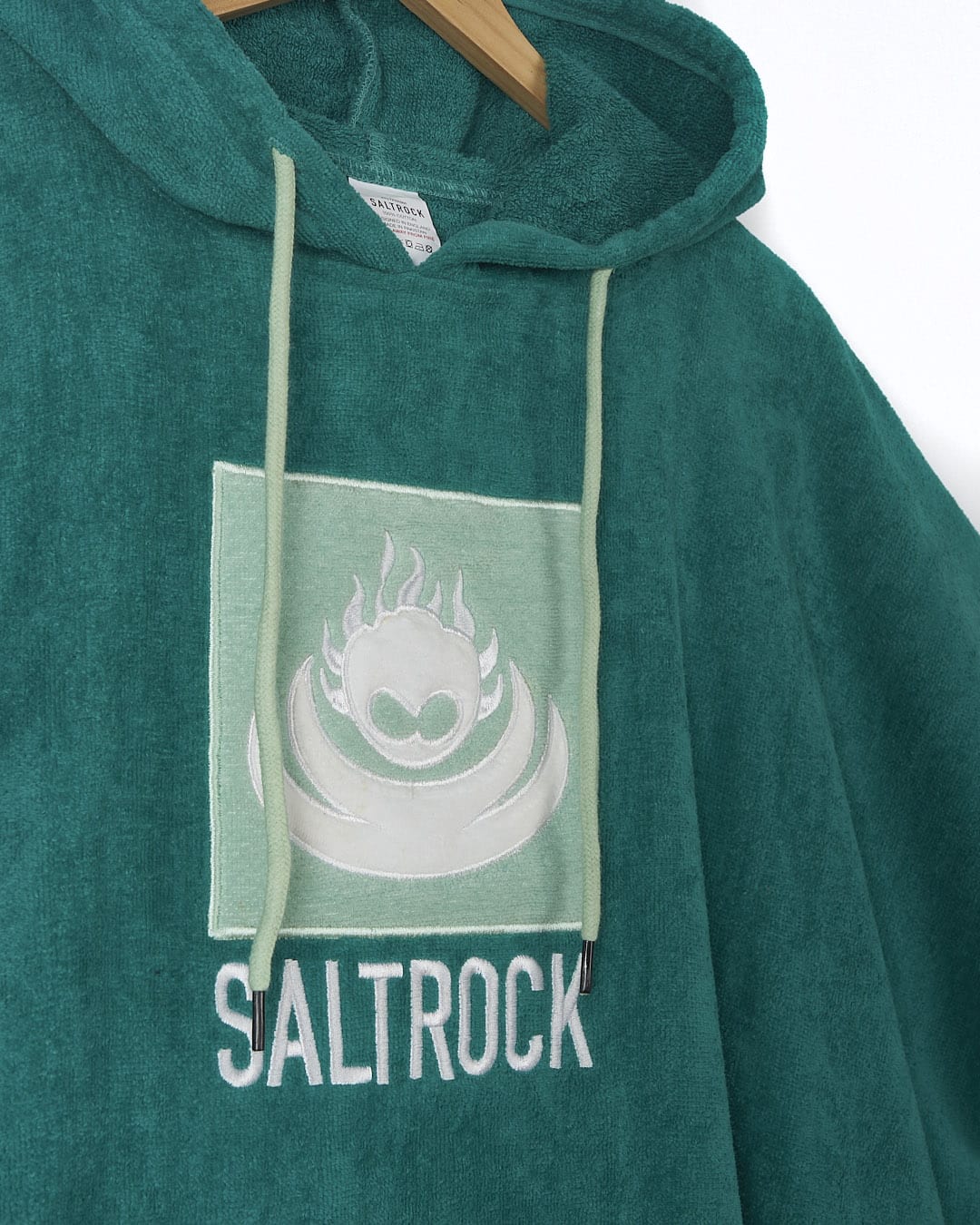 A green Corp Changing Towel - Turqouise with the word Saltrock on it.