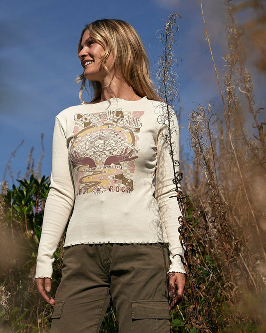 A woman wearing a Saltrock Cosmic Soul - Ribbed Long Sleeve T-Shirt - Cream standing in tall grass.