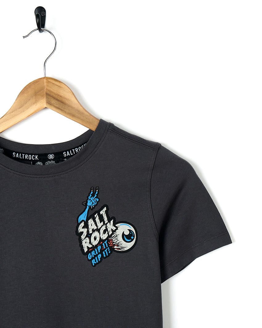 A grey Creepshow - Kids Short Sleeve T-Shirt with a blue eye and Saltrock graphics.
