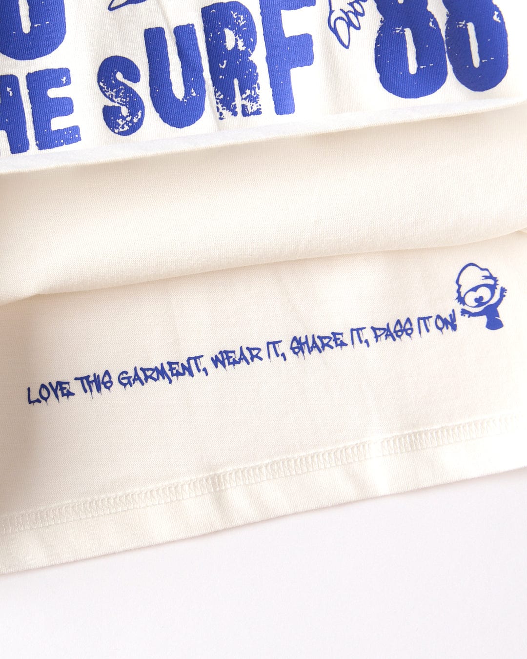 The Saltrock Dawn Ready Kids T-Shirt in white features blue "LOVE THIS GARMENT, WEAR IT, SHARE IT, PASS IT ON!" text with a cartoon face. Made from 100% cotton and machine washable for everyday comfort.