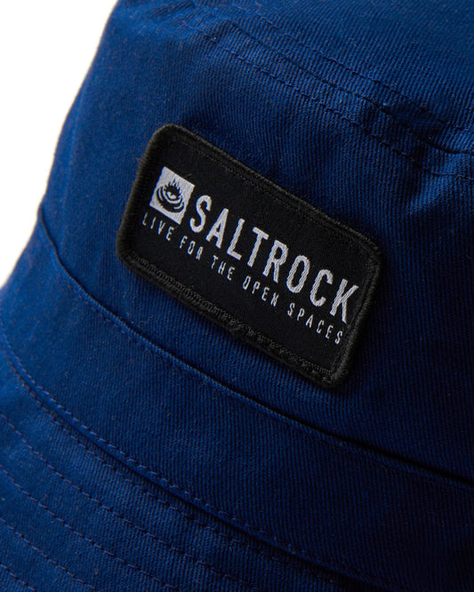 Blue nylon Dockyard bucket hat with a black Saltrock logo patch.