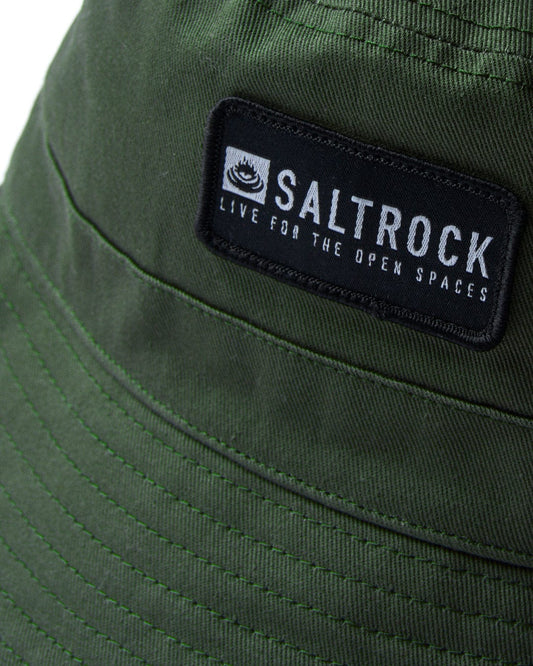 Close-up of a green cotton Saltrock-branded Dockyard - Bucket Hat - Green with a logo patch from North Devon.