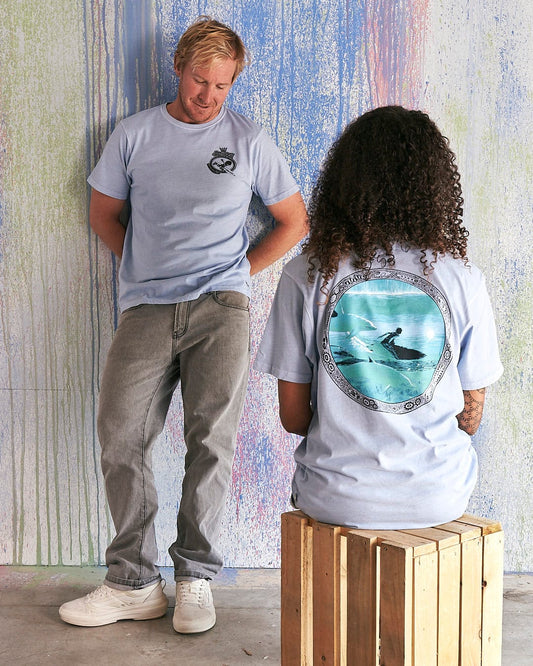 A man and a woman are sitting on a Saltrock - Dolphin Limited Edition 35 Years T-Shirt.