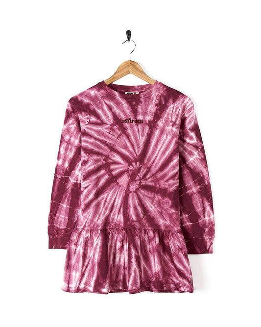 An Effie - Kids Tie Dye Sweatdress - Pink by Saltrock hanging on a hanger.