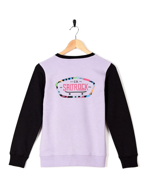 A Saltrock Elissa - Kids Crew Sweat - Light Purple sweater on a swinger.