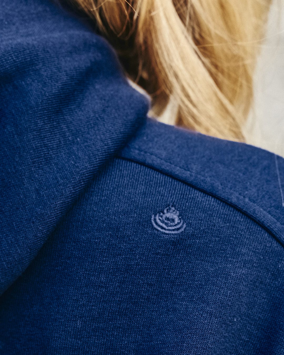 A stylish Saltrock woman's Elsa - Womens Hooded Sweat Dress - Dark Blue, combining both comfort and a logo design on the back.