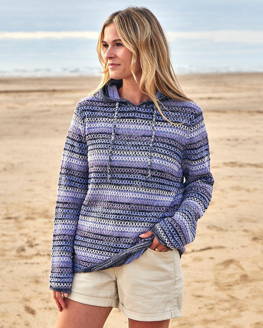 A woman wearing a Saltrock Erin - Womens Hooded Knitted - Light Purple hoodie and shorts on the beach.