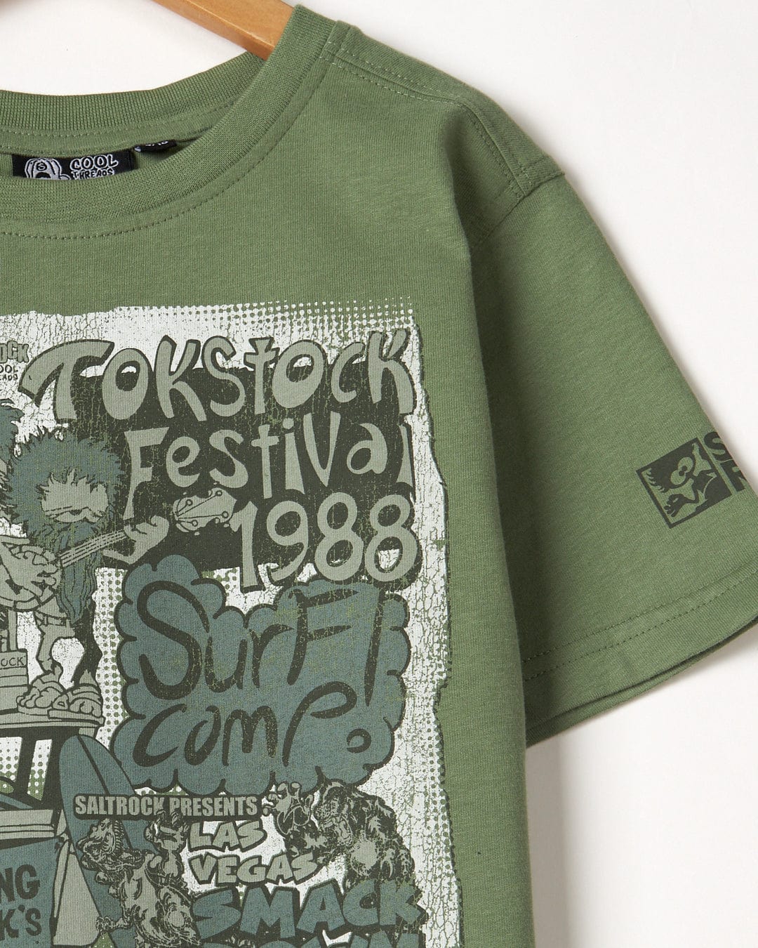 A green cotton t-shirt with the words Saltrock Festival Merch on it.