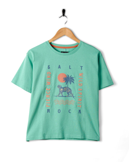 Saltrock Fierce Mind - Womens Cropped T-Shirt - Green with tropical graphic design hanging on a wall-mounted hook.