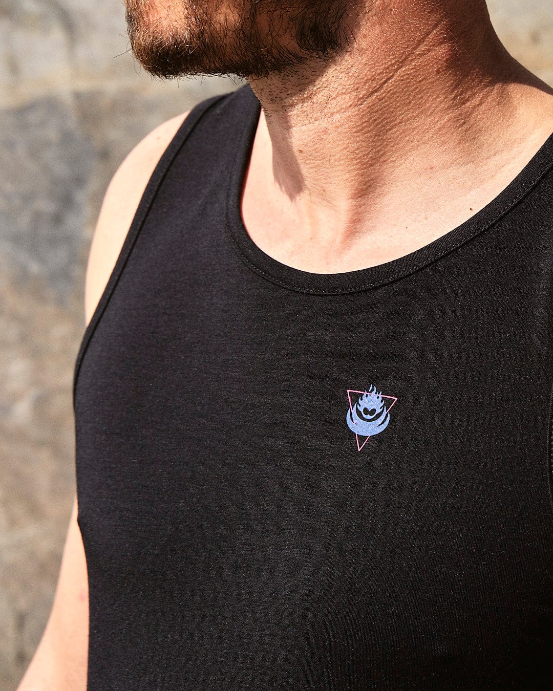 A man wearing a Saltrock Flame Tri - Mens Recycled Vest - Black with a smiley face on it.
