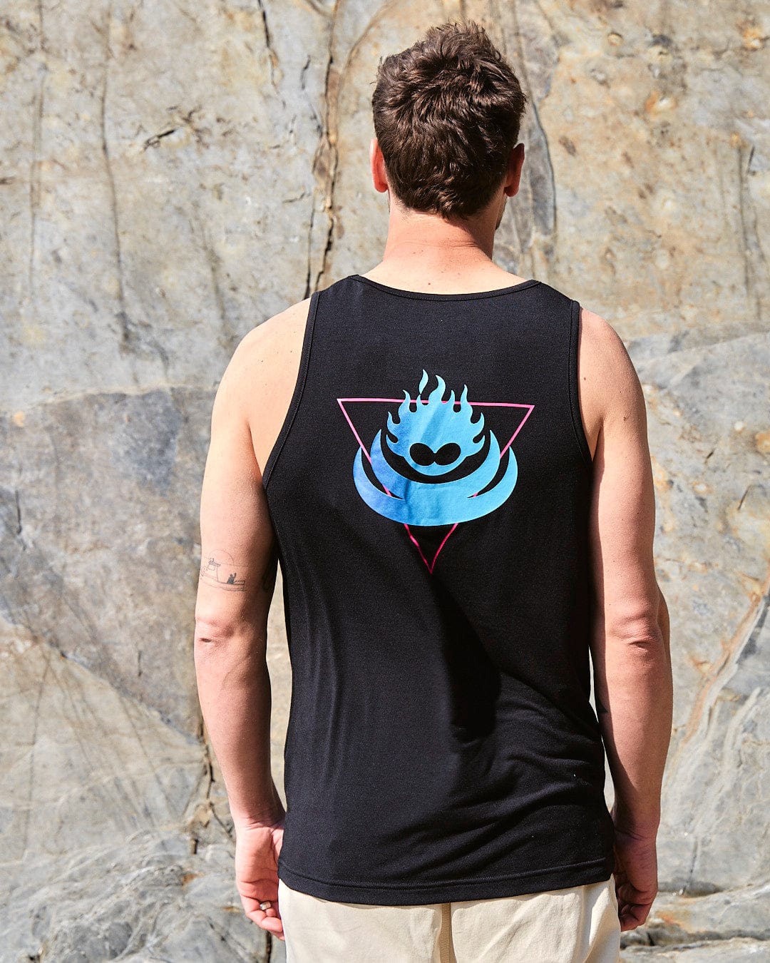 The back of a man wearing a Saltrock Flame Tri - Mens Recycled Vest - Black with a blue flame on it.