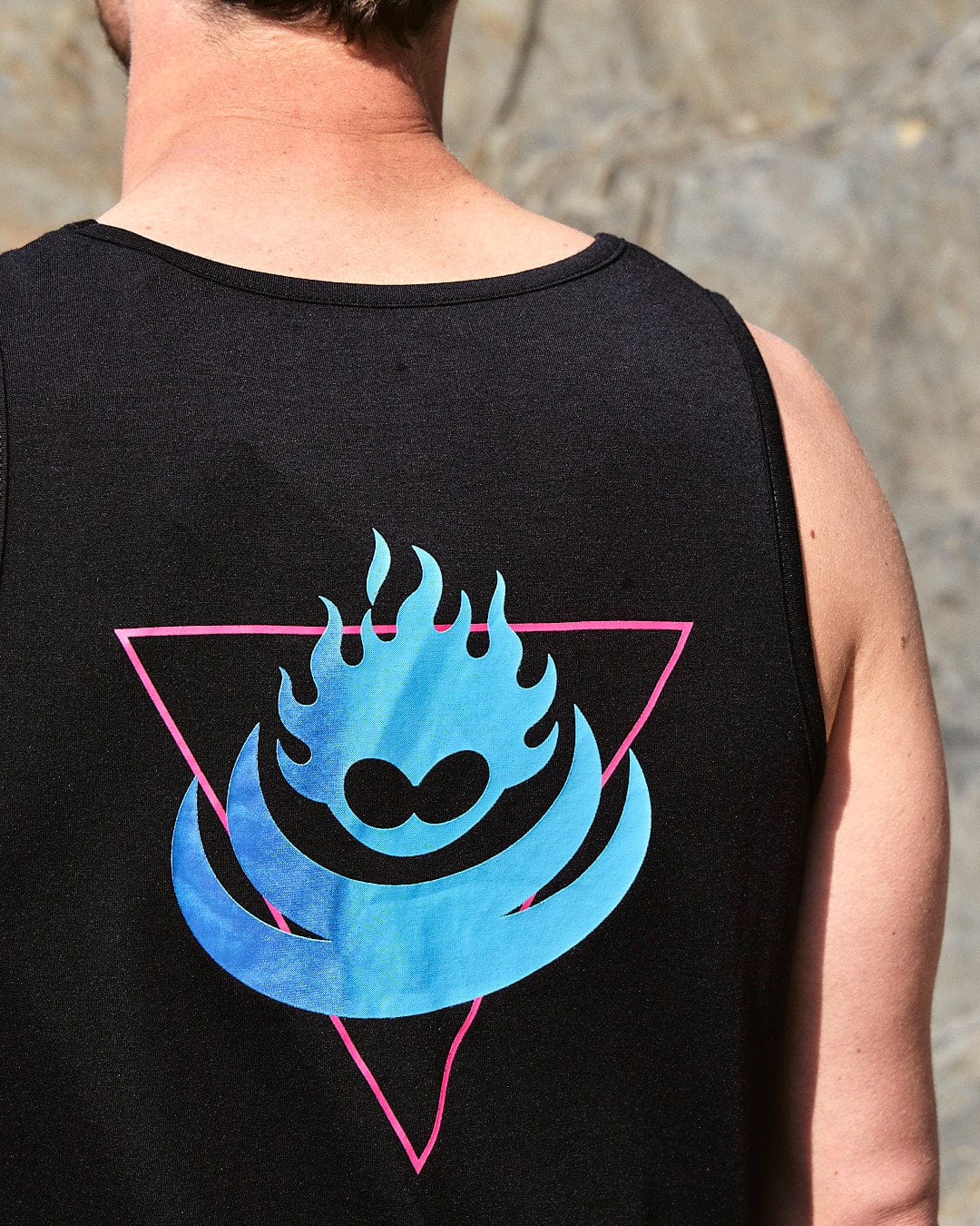 The back of a man wearing a Saltrock Flame Tri - Mens Recycled Vest - Black with a blue flame on it.