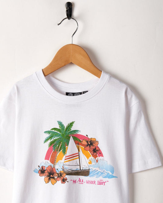 Floral Lost Ships - Kids Short Sleeve T-Shirt - White - SS24 made by Saltrock, with a tropical beach design including a sailboat and palm trees, hanging on a wall-mounted hook. The text "not all who wander are lost.
