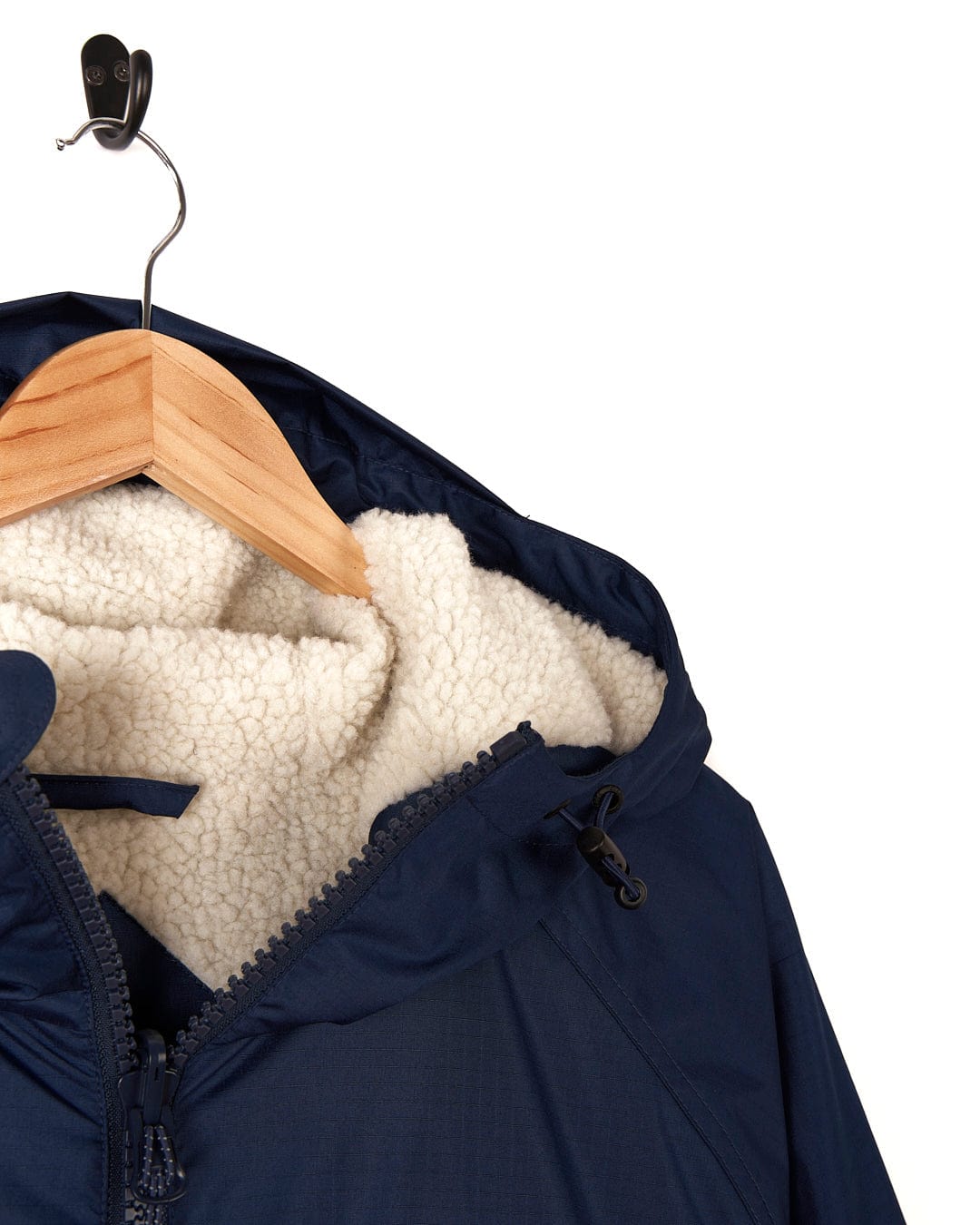 A Saltrock Four Seasons - Waterproof Changing Robe - Blue with a sherpa lining hanging on a hanger.