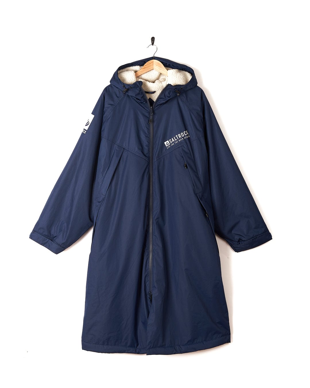 A Saltrock Four Seasons - Waterproof Changing Robe - Blue hooded raincoat hanging on a hanger.