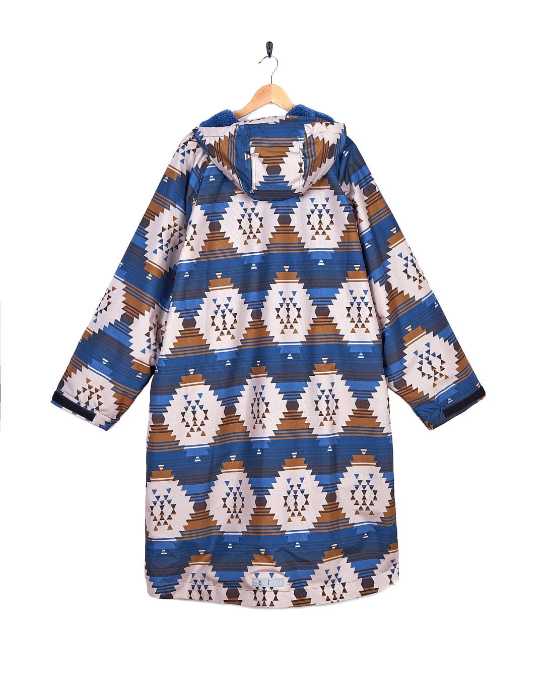 A blue and brown Four Seasons Changing Robe - Aztec coat hanging on a hanger, made by Saltrock.