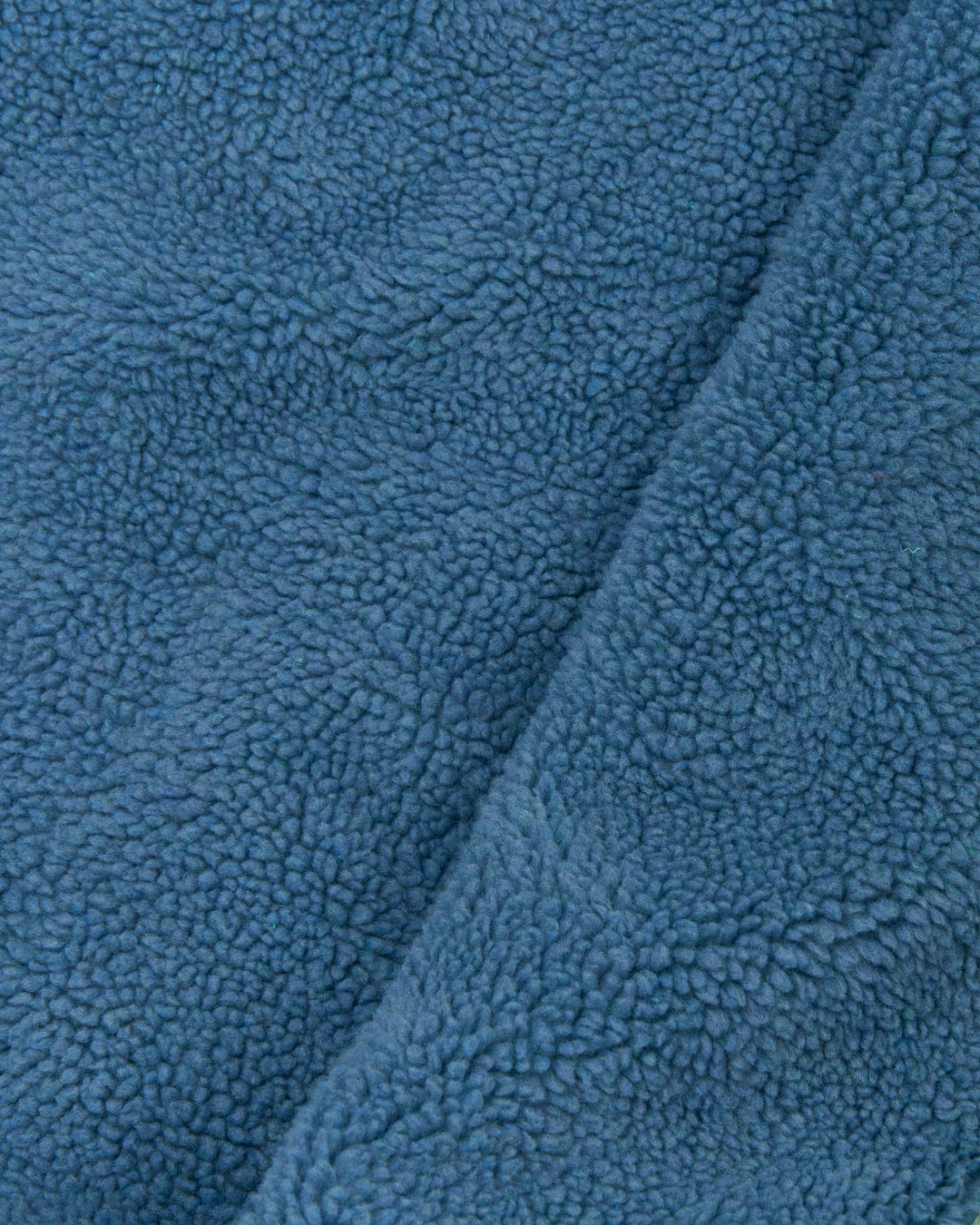 Close-up of a blue, soft, and textured fleece fabric, showing its fluffy and cozy surface. This Recycled Changing Robe - Light Green from Saltrock is crafted from recycled materials for ultimate comfort and sustainability.