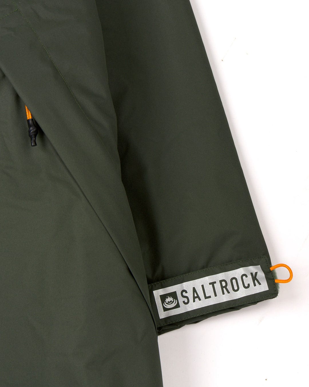 Saltrock green recycled Four Seasons changing robe with Aztec design and brand label visible.