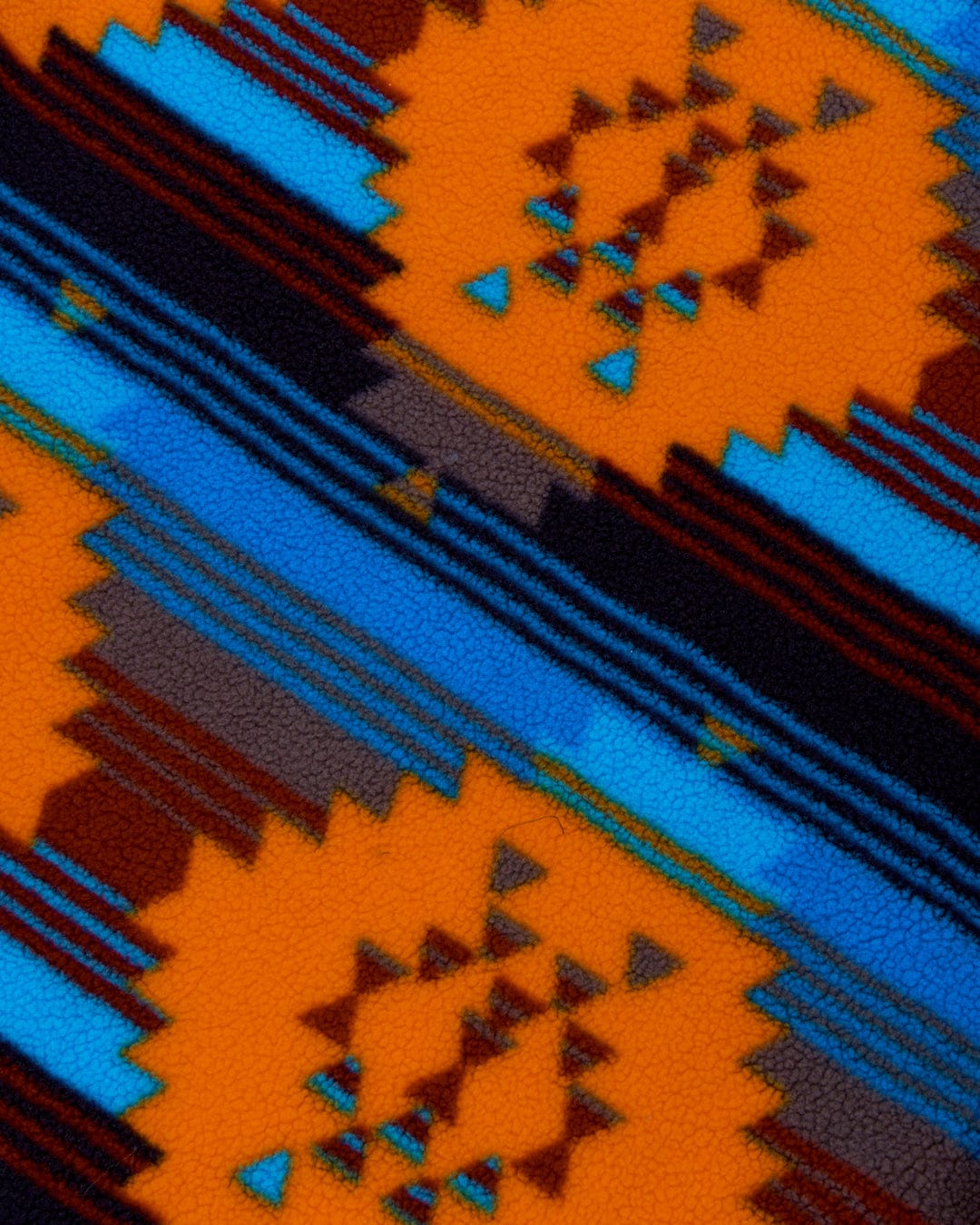 Close-up of a textured, waterproof Saltrock Recycled Four Seasons Changing Robe fabric with a geometric pattern in warm and cool tones and fleece lining.