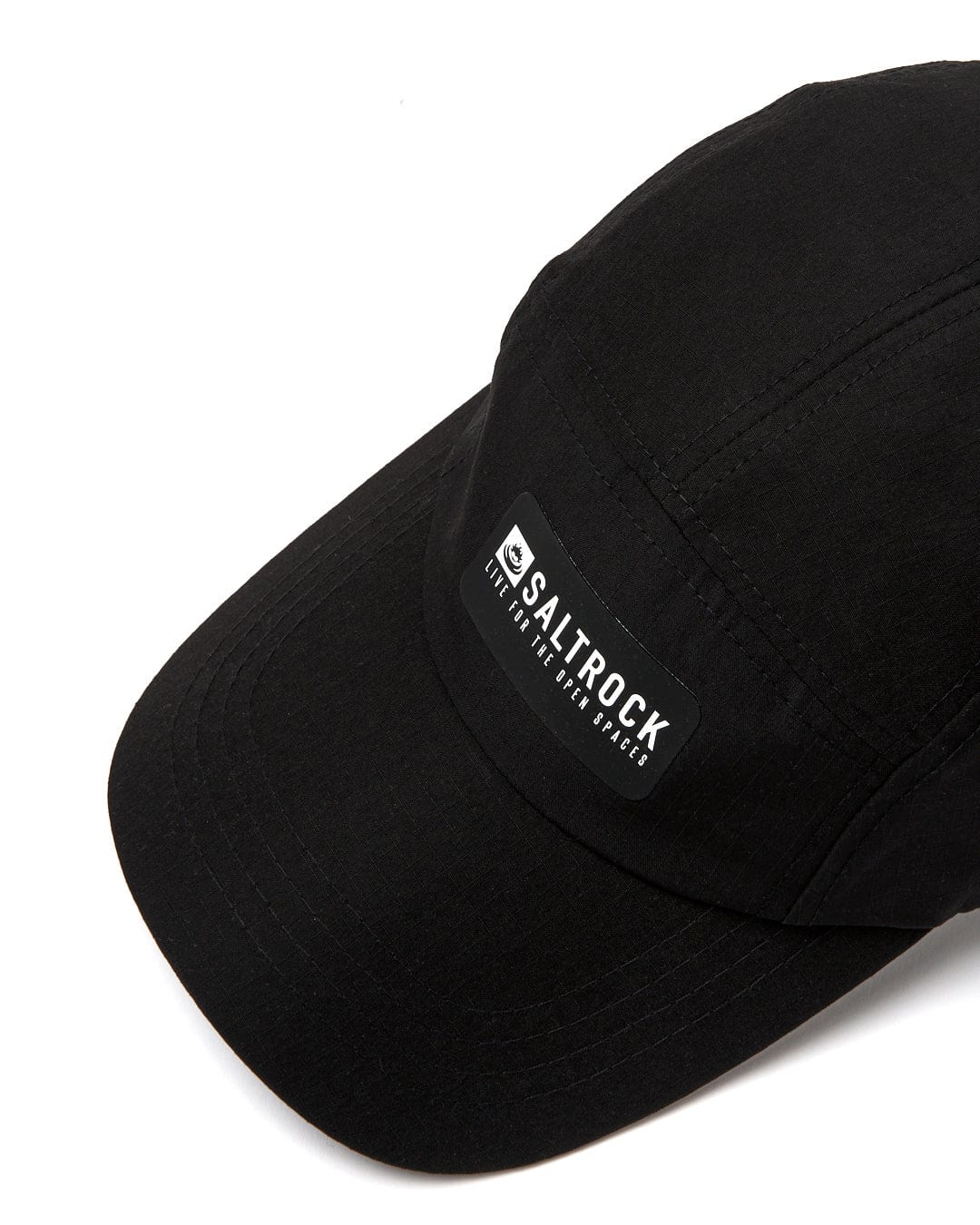 A Saltrock Gaitor 5 Panel UPF Cap in black with an adjustable strap and a white logo.