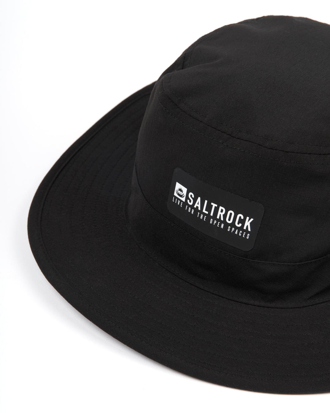 A black gaitor hat with Saltrock branding.