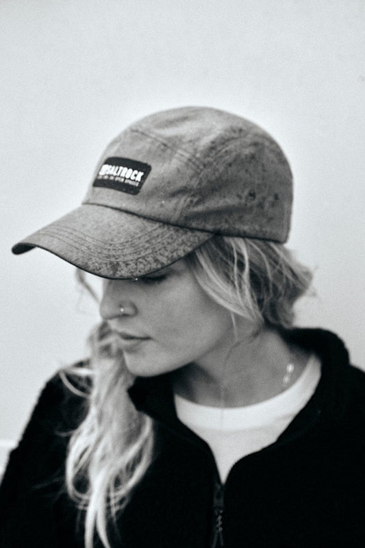 A black and white photo of a woman in a Saltrock Gaitor 5 Panel UPF Cap - Green with an adjustable strap.